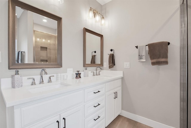 bathroom featuring vanity and a shower with door