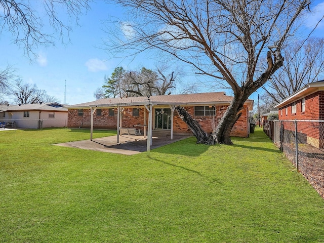 rear view of house with a patio area and a lawn