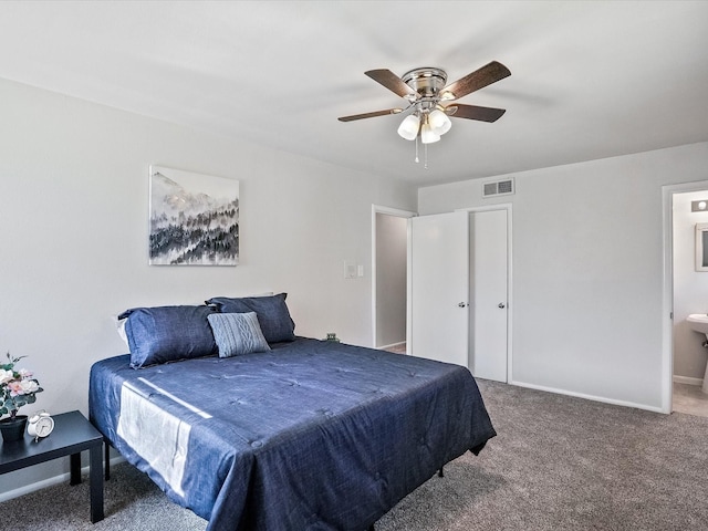 carpeted bedroom with connected bathroom and ceiling fan