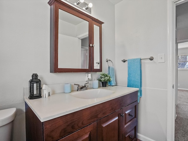 bathroom with vanity and toilet