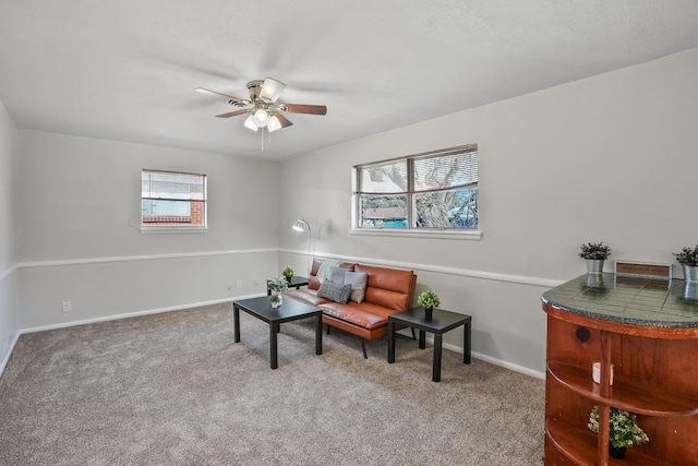 living area with plenty of natural light, carpet floors, and ceiling fan