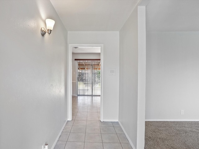 hall featuring light tile patterned flooring