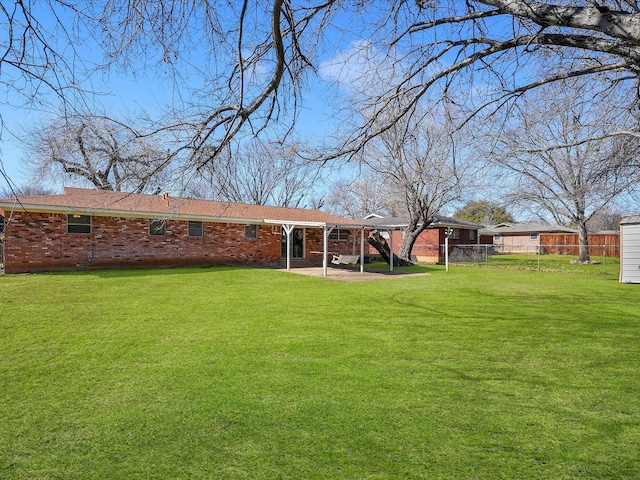 rear view of house with a yard and a patio area