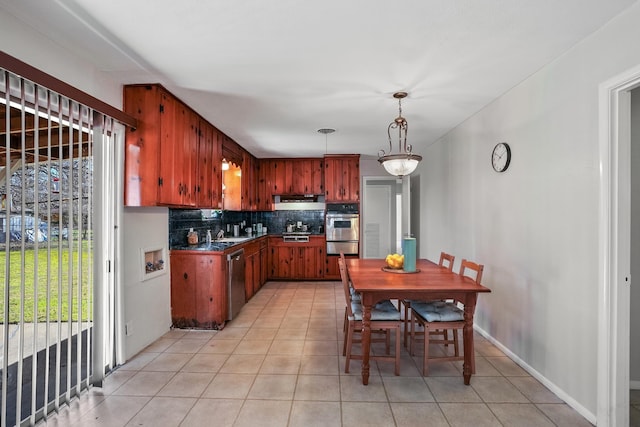 kitchen with hanging light fixtures, tasteful backsplash, appliances with stainless steel finishes, and light tile patterned floors