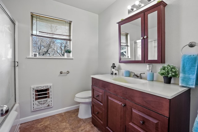 full bathroom with shower / bath combination with glass door, vanity, toilet, and heating unit