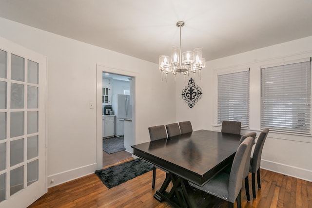 dining room featuring hardwood / wood-style floors and a notable chandelier