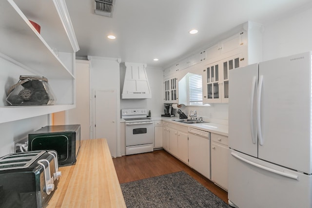 kitchen with white cabinetry, sink, white appliances, and premium range hood