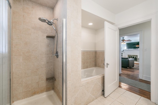 bathroom with ceiling fan, independent shower and bath, and tile patterned flooring