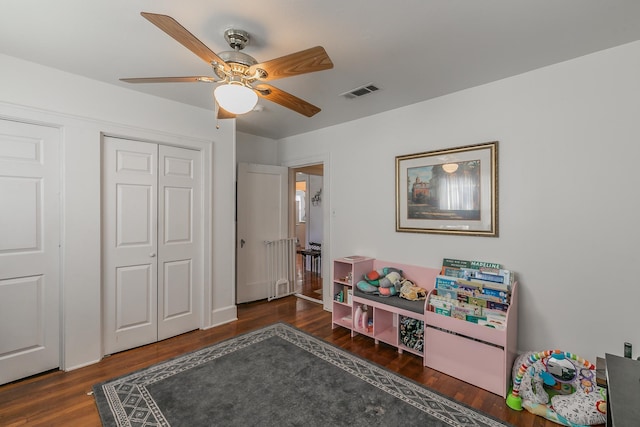 playroom featuring dark hardwood / wood-style floors and ceiling fan