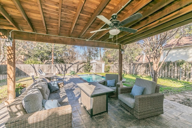 view of patio with a fenced in pool, outdoor lounge area, and ceiling fan