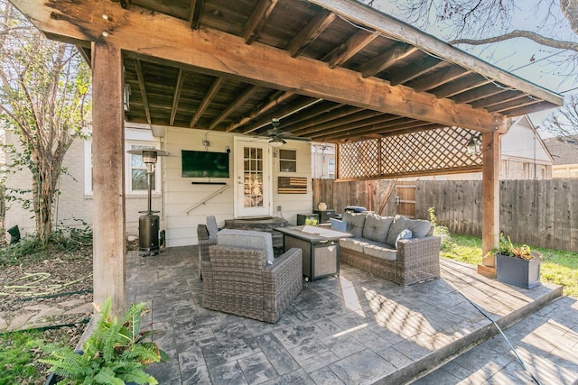 view of patio featuring an outdoor living space with a fire pit and ceiling fan