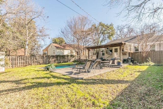 view of yard with a fenced in pool, ceiling fan, and a patio area