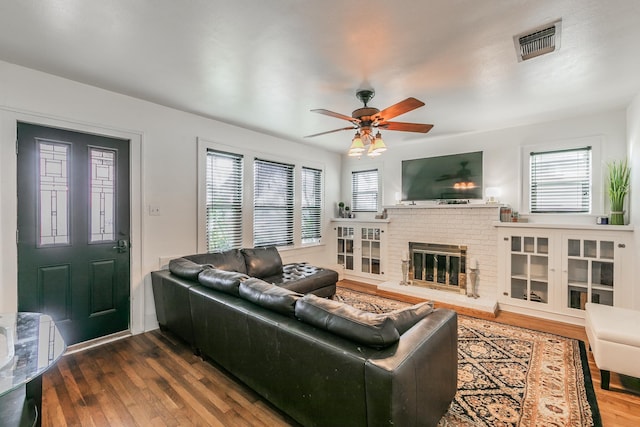 living room featuring hardwood / wood-style flooring, ceiling fan, a healthy amount of sunlight, and a fireplace