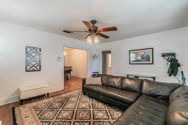 living room with hardwood / wood-style floors and ceiling fan