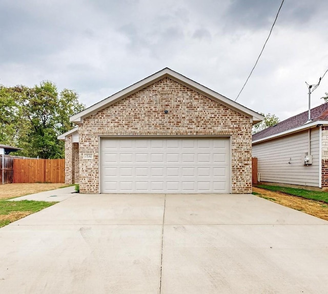 ranch-style house featuring a garage, brick siding, an outdoor structure, and fence