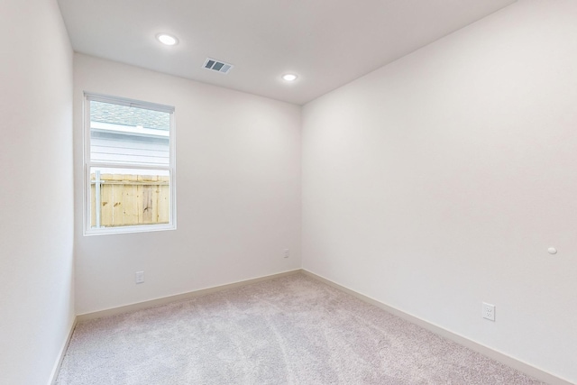 spare room with recessed lighting, baseboards, visible vents, and light colored carpet