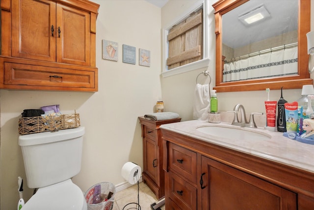 bathroom with vanity, tile patterned floors, and toilet