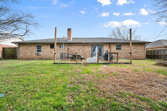 back of property featuring a lawn