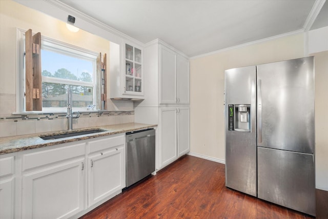 kitchen featuring stainless steel appliances, white cabinetry, sink, and light stone counters