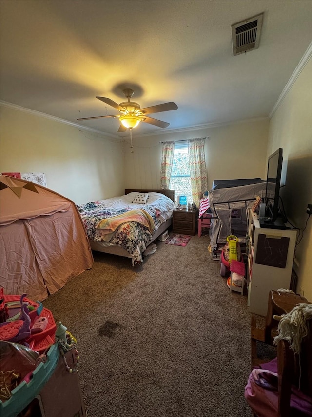 bedroom with a ceiling fan, crown molding, visible vents, and carpet flooring