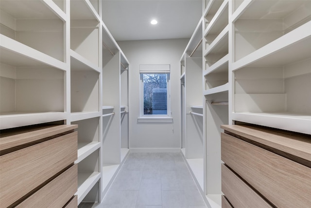 walk in closet with light tile patterned flooring