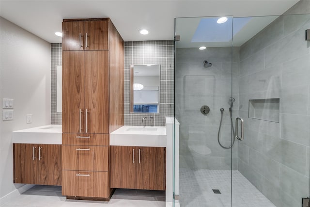 bathroom featuring tile patterned flooring, vanity, and walk in shower