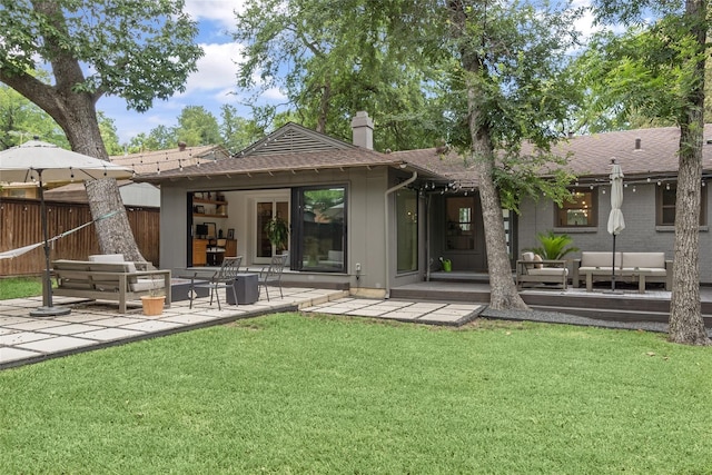 back of house with a patio, outdoor lounge area, and a yard