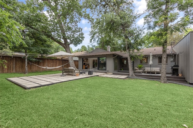 back of house with a yard and a patio area