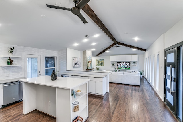 kitchen featuring a kitchen island, white cabinetry, vaulted ceiling with beams, stainless steel dishwasher, and ceiling fan