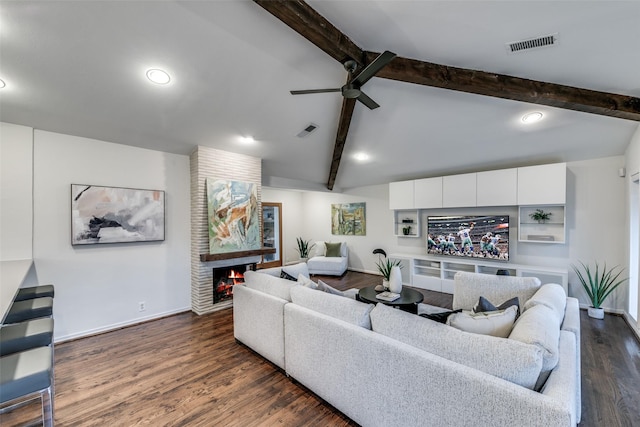 living room with lofted ceiling with beams, ceiling fan, dark hardwood / wood-style floors, and a fireplace