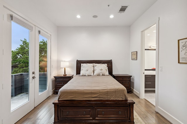 bedroom featuring french doors, ensuite bath, access to exterior, and light wood-type flooring