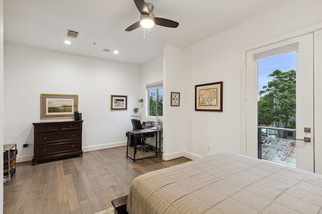 bedroom with multiple windows, hardwood / wood-style floors, and ceiling fan