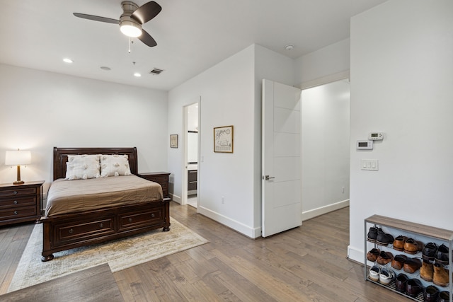 bedroom with ceiling fan and light hardwood / wood-style flooring