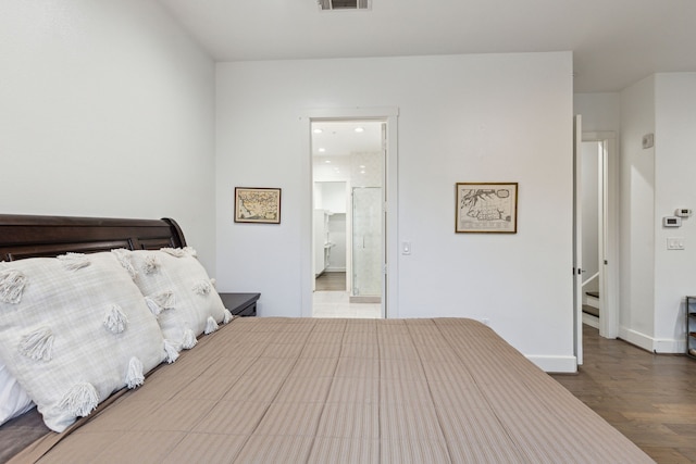 bedroom with hardwood / wood-style flooring and ensuite bathroom