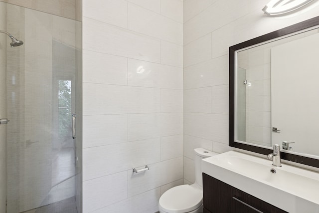 bathroom featuring vanity, tile walls, walk in shower, and toilet