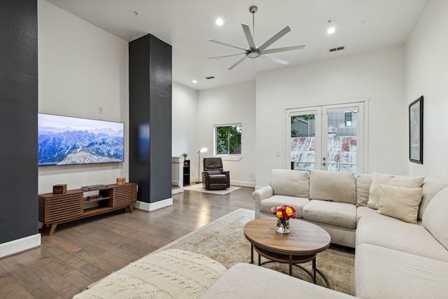 living room featuring ceiling fan and dark hardwood / wood-style flooring