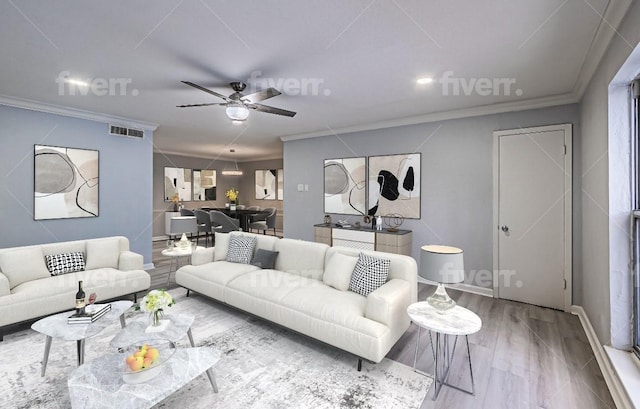 living room with hardwood / wood-style flooring, ornamental molding, and ceiling fan