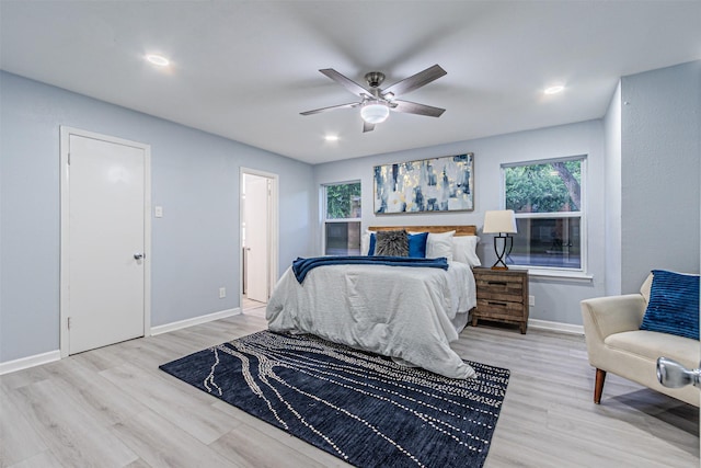 6004 E University Blvd Unit 131, Dallas, TX 75206 - bedroom with baseboards, ceiling fan, recessed lighting, and light wood-style flooring