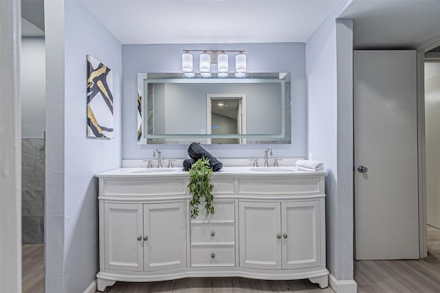 6004 E University Blvd Unit 131, Dallas, TX 75206 - bathroom with a sink, baseboards, double vanity, and wood finished floors