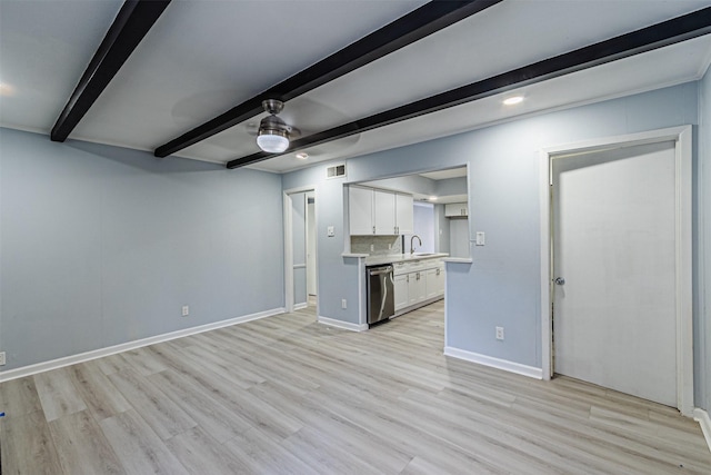 kitchen featuring sink, white cabinets, beam ceiling, stainless steel dishwasher, and light wood-type flooring