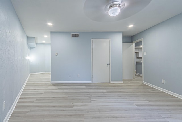 spare room featuring ceiling fan and light hardwood / wood-style flooring