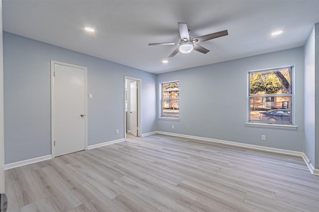 unfurnished room featuring ceiling fan, plenty of natural light, and light hardwood / wood-style floors