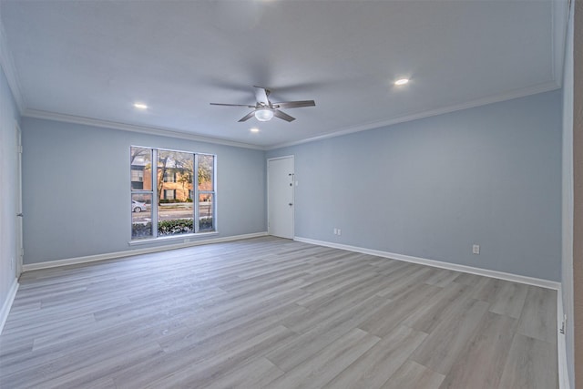 spare room featuring ornamental molding, ceiling fan, and light wood-type flooring