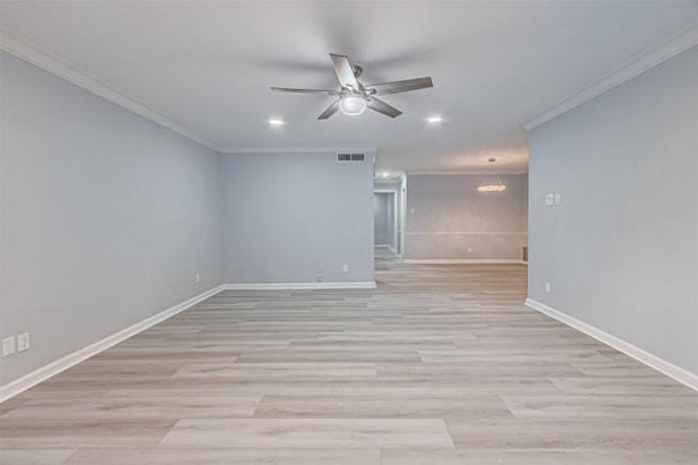 empty room featuring crown molding, ceiling fan with notable chandelier, and light hardwood / wood-style floors