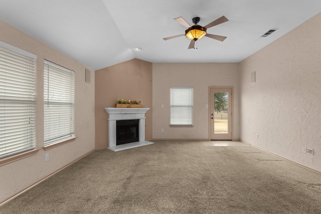 unfurnished living room featuring lofted ceiling, carpet floors, and ceiling fan