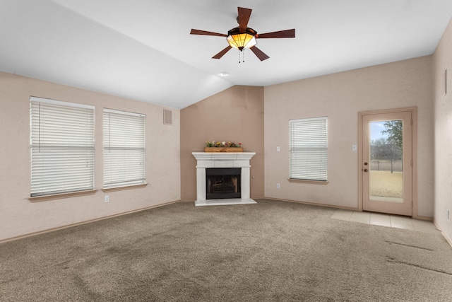 unfurnished living room featuring vaulted ceiling, light carpet, and ceiling fan