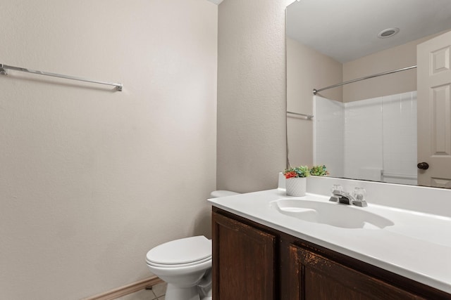 bathroom featuring walk in shower, tile patterned floors, vanity, and toilet