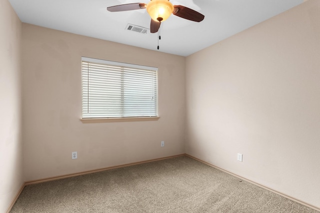 empty room with ceiling fan and carpet