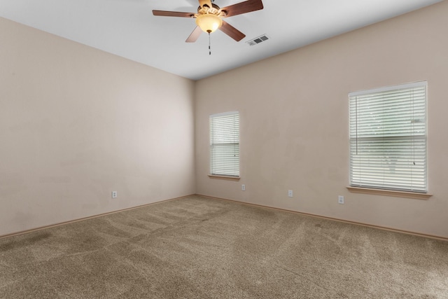 empty room with carpet floors and ceiling fan