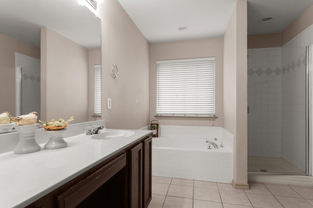 bathroom featuring plus walk in shower, tile patterned floors, and vanity